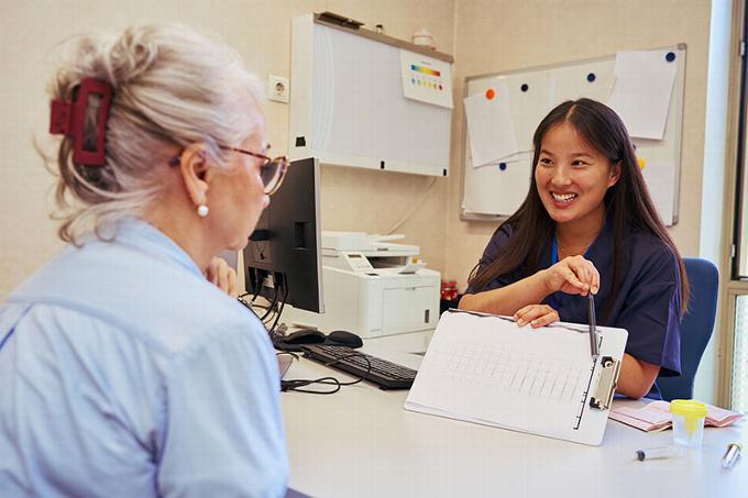 Female doctor talking with elder woman