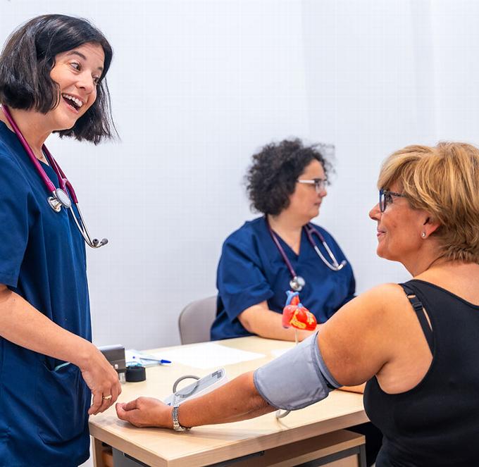 Nurse checking blood pressure on patient 