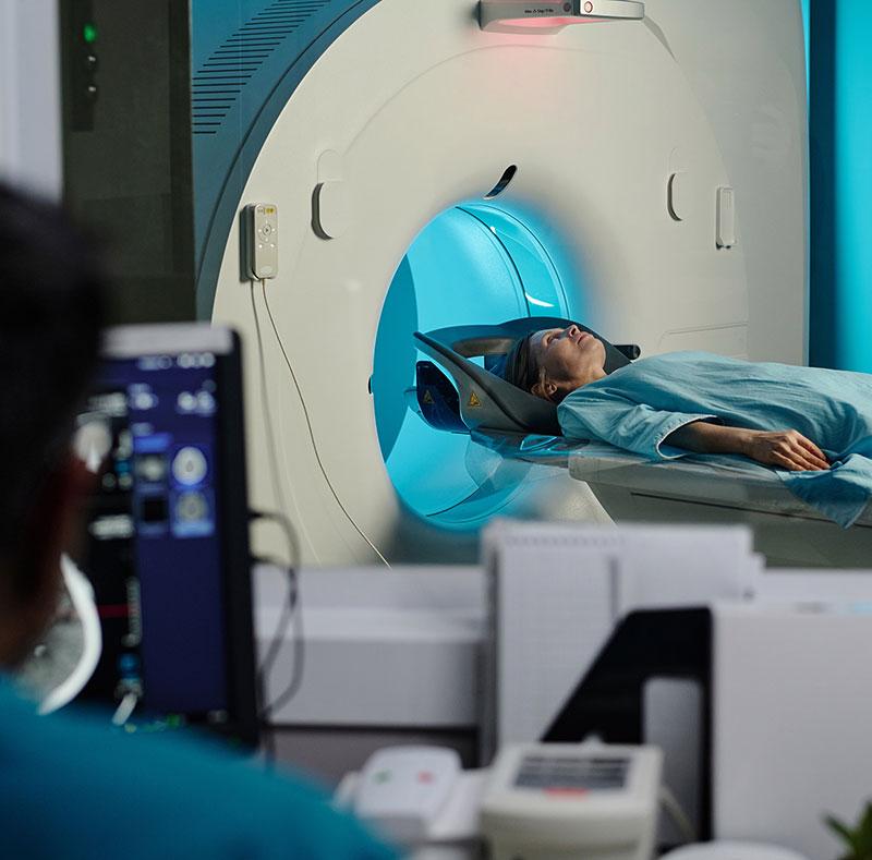 CT scan in progress with doctor looking at screen